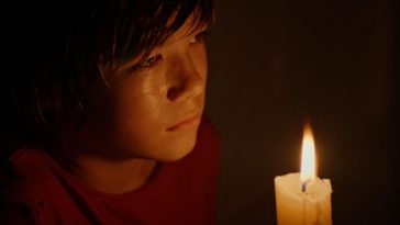 Dylan holding a candle