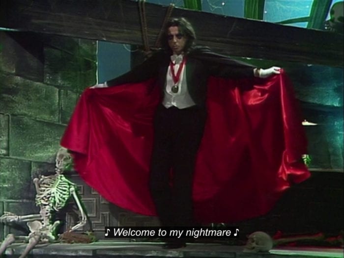 Alice Cooper, dressed as a vampire, spreads his cape and sings, "Welcome to my nightmare," in the TV show, "The Muppet Show."