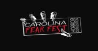 An illustration of a skeleton hand holding a card that reads "CAROLINA FEAR FEST" in the center, and "HORROR CONVENTION) vertically on the right side. Everything is white on a black background, except for the text "FEAR FEST", which is red.