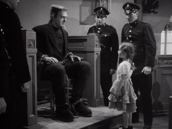 Frankenstein looking at a little girl