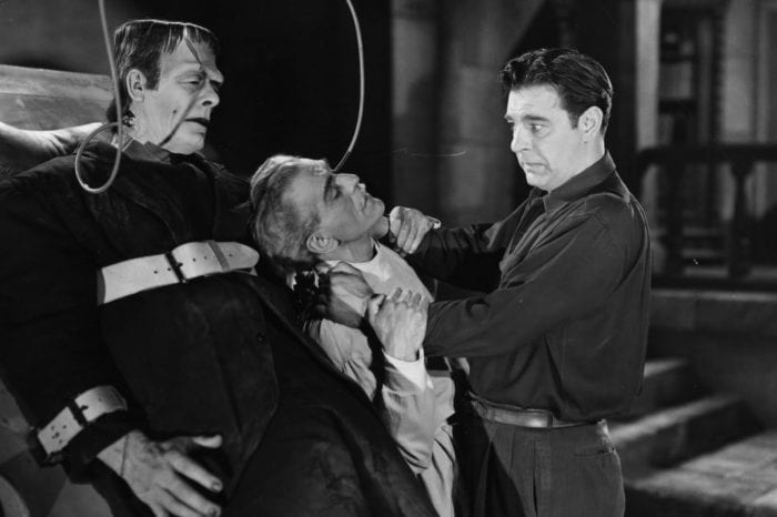 Lawrence Talbot choking Dr. Niemann in front of Frankenstein