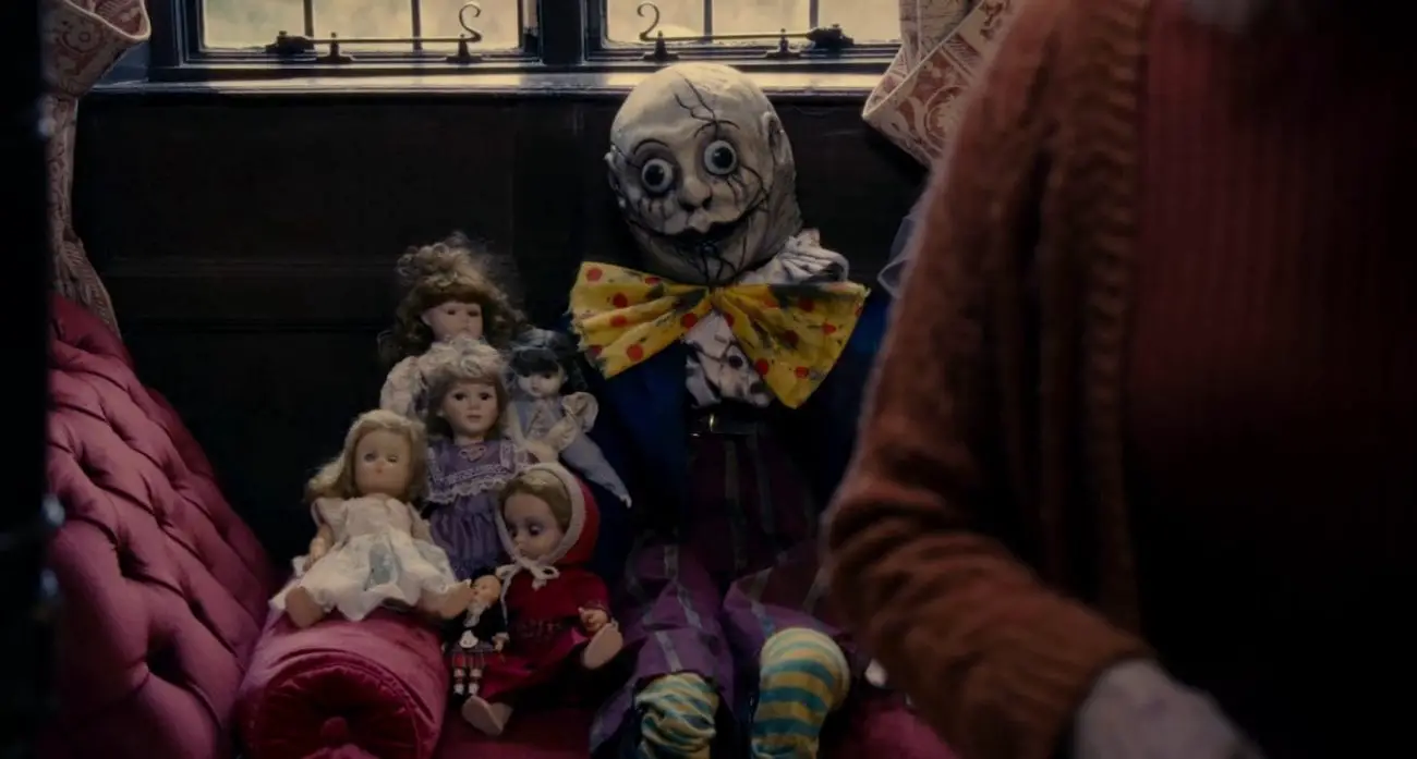 The Humpty Dumpty doll sitting with other dolls