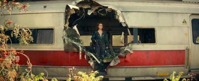 Regan standing in a hole in a train car