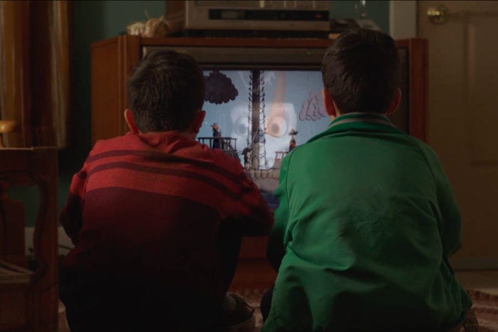 Young Eddie and Mike (Luca Villacis) sitting in front of their 80s TV watching Candle Cove together 