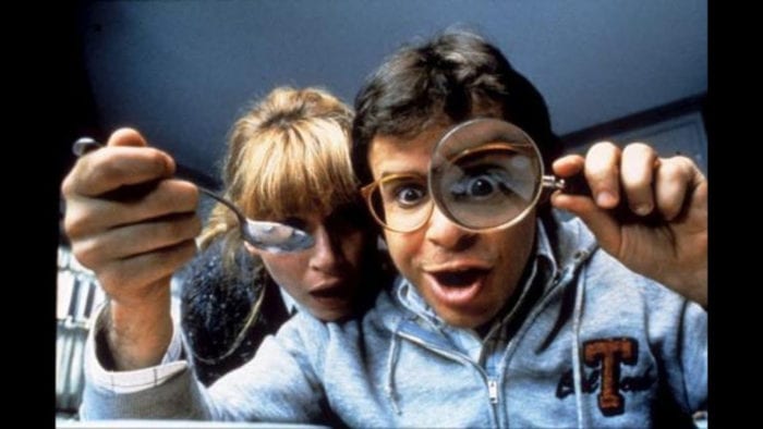Clip from Honey I shrunk the kids showing father and mother looking through magnifying glass at kids.