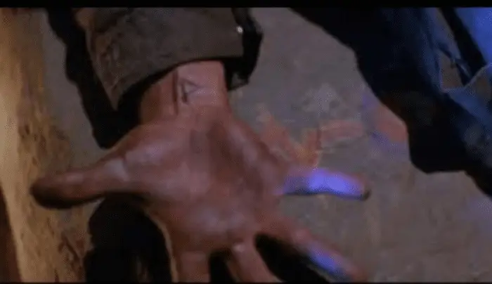 A shot of Michael Myers's hand, fingers outstretched and palm up; a runic symbol tattoo is visible on his wrist.