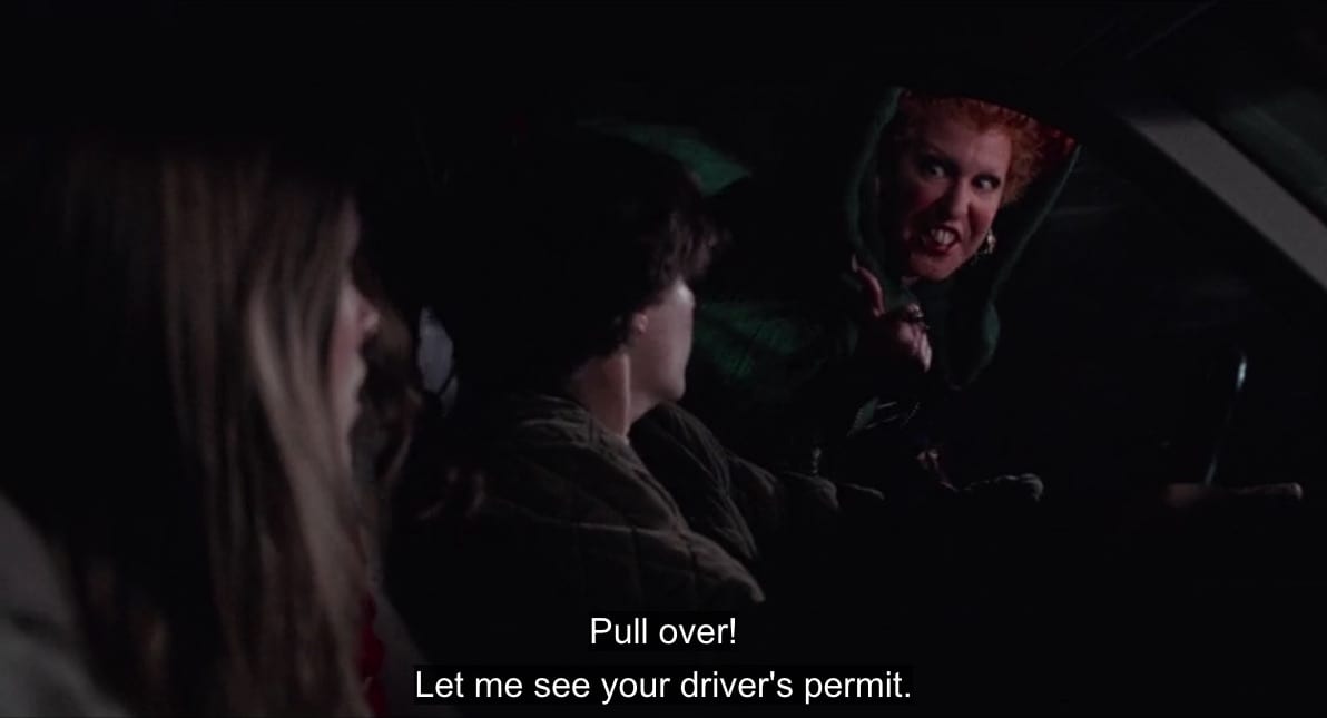 Winifred Sanderson (Bette Midler) flies alongside a car on her broomstick and barks through the open window, "Pull over! Let me see your driver's permit," in the film "Hocus Pocus" (1993).