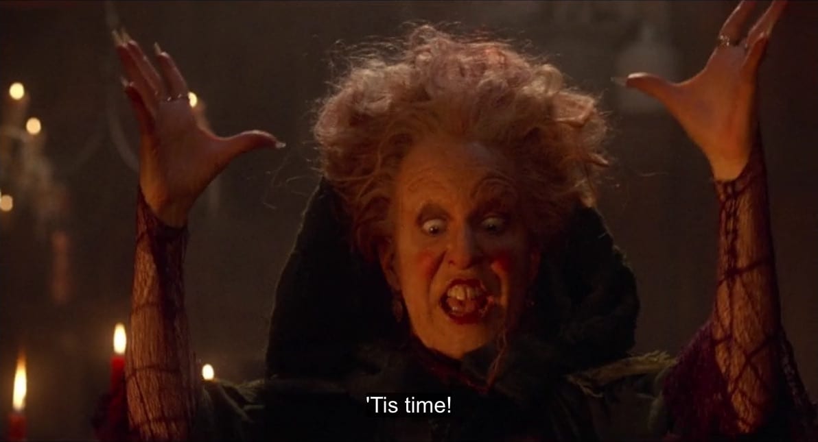 Winifred Sanderson (Bette Midler) raises her arms and says, "'Tis time!", in the film, "Hocus Pocus" (1993).
