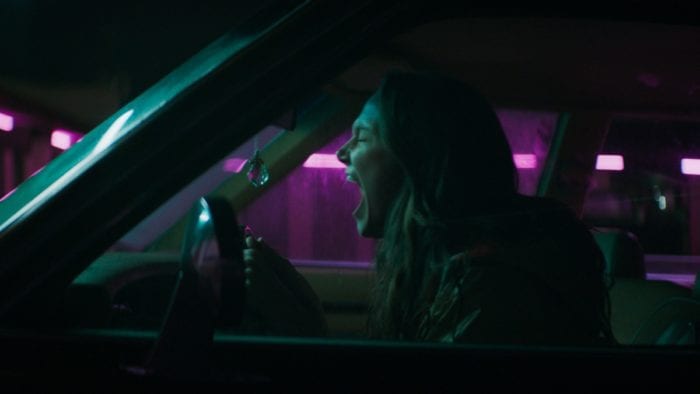 Laura (Andi Matichak) sits in her car after realizing what she must do in order to keep her son alive and safe