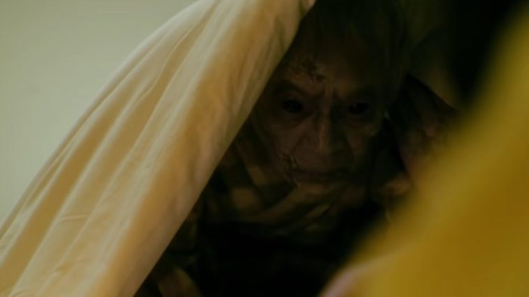 A creepy guy under a bedsheet
