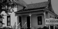 black and white image of the Villisca Ax Murder House with sign out front.