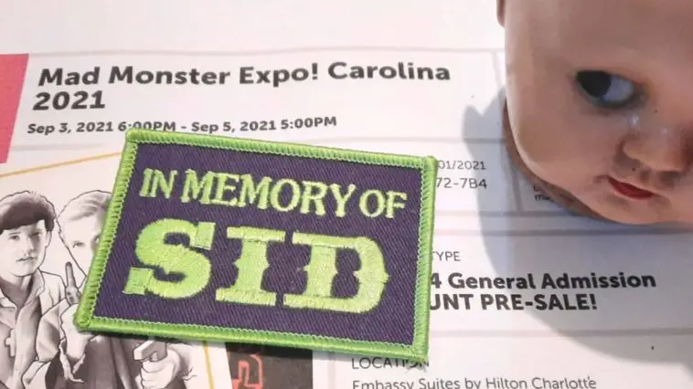 Image of a Mad Monster Expo ticket with a creepy baby doll head, a card with "Fright Night's" Peter Vincent and Charlie Brewster, and a patch memorializing Sid Haig.