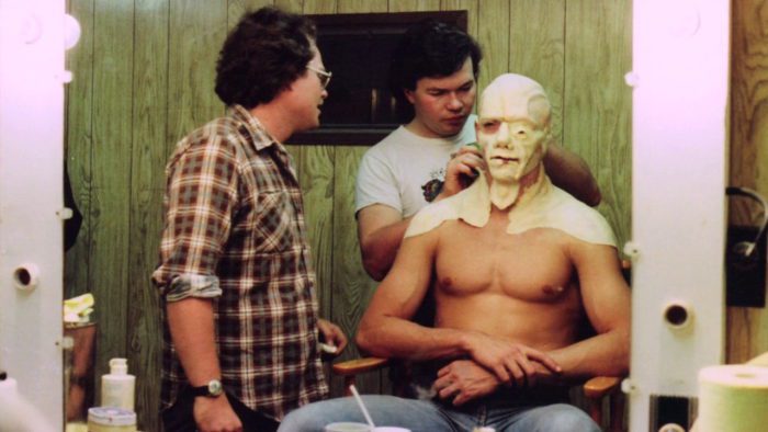 Richard Brooker, shirtless, having the Jason makeup applied to his head