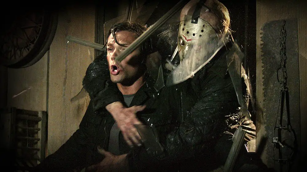 Jason claims another victim by bursting through the wall.