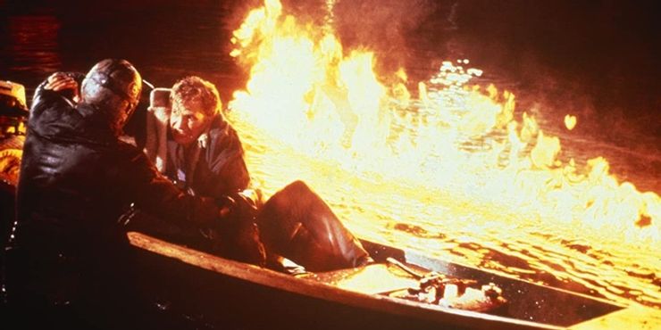 Jason and Tommy fight on a canoe near an oil fire on Crystal Lake