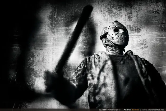 Jason Voorhees in iconic hockey mask standing in black and white