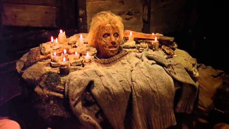 Pamela Voorhees head as a shrine, surrounded by candles