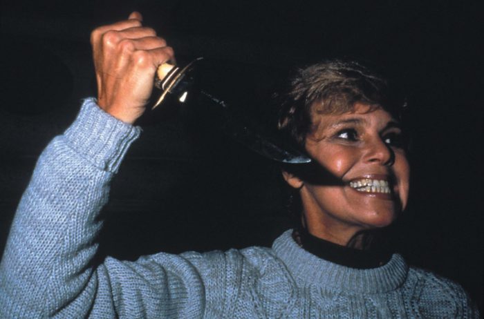 Pamela Voorhees grins maniacally while wielding a butcher knife.