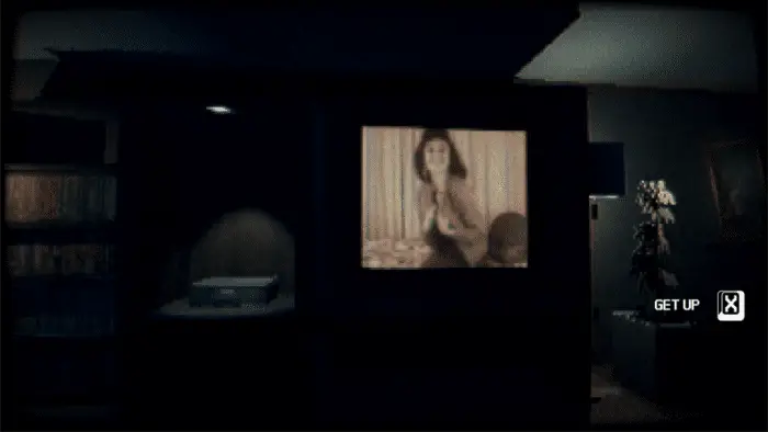 a living room with a TV. on the screen is a woman in lingerie