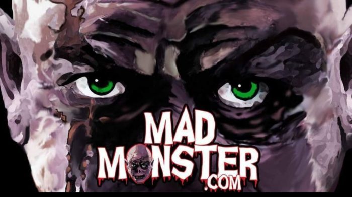 Mad Monster logo- A monster face with piercing green eyes stares back at you.