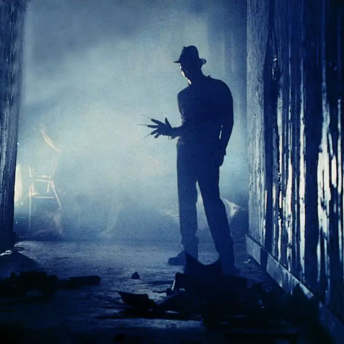 Freddy stands off in the distance, almost as a silhouette with his glove pointed outward.