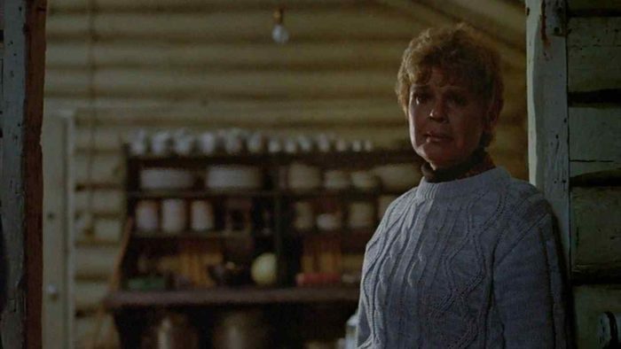 Pamela Voorhees stands in the door of a Camp Crystal Lake cabin.