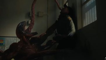 Carnage choking a guy with his symbiote appendages