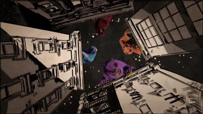The four dream beavers (blue, dark red, orange, and purple) looking down from the tops of four different buildings. They are the only computer generated objects in the black-and-white comic city.