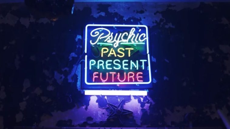 A neon sign eerily lit says "Psychic: Past, Present, Future