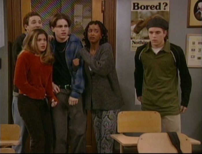 The group stand in awe as they spot a message on the chalkboard that has been written in blood.