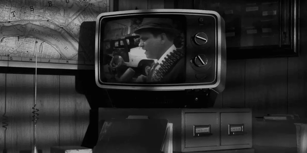 Black and white image of a vintage TV showing a news scene from "Night of the Living Dead."