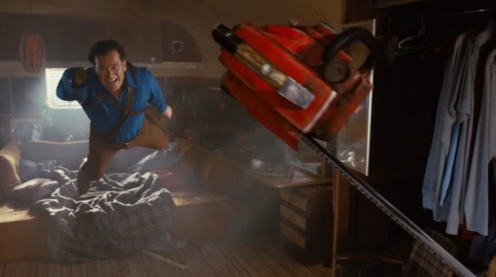 Ash Williams (Ash vs the Evil Dead) leaps through the air to get his chainsaw hand on so he can fight a deadite.
