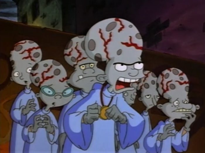 Helga and her friends dressed in white robes and giant veiny heads to appear as aliens