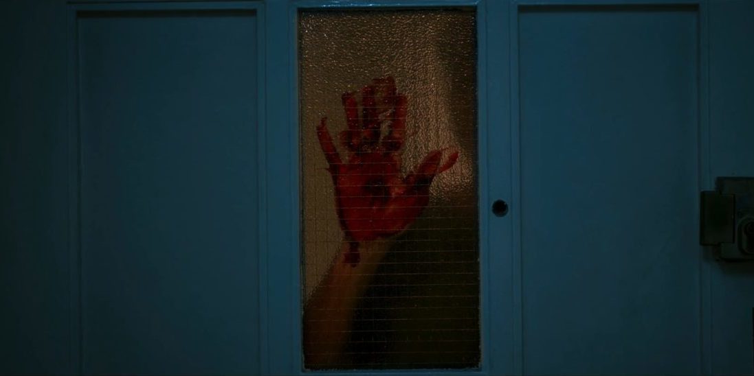 A bloody hand on a pane of glass in Lair