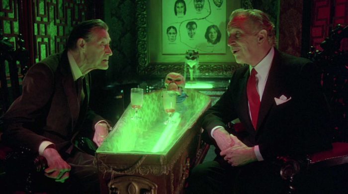 Two old men, played by John Carradine (left) and Vincent Price (right) engage in conversation.
