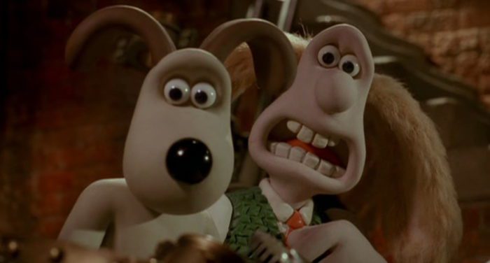 Gromit the dog (left) and Wallace (right) stand next to each other with terrified expressions.