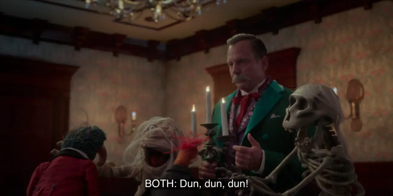 A Muppet mummy and a Muppet skeleton jump in front of Host (Will Arnett) to say, "Dun dun dun!" to Gonzo and Pepé the King Prawn, in the 2021 special, "Muppets Haunted Mansion."
