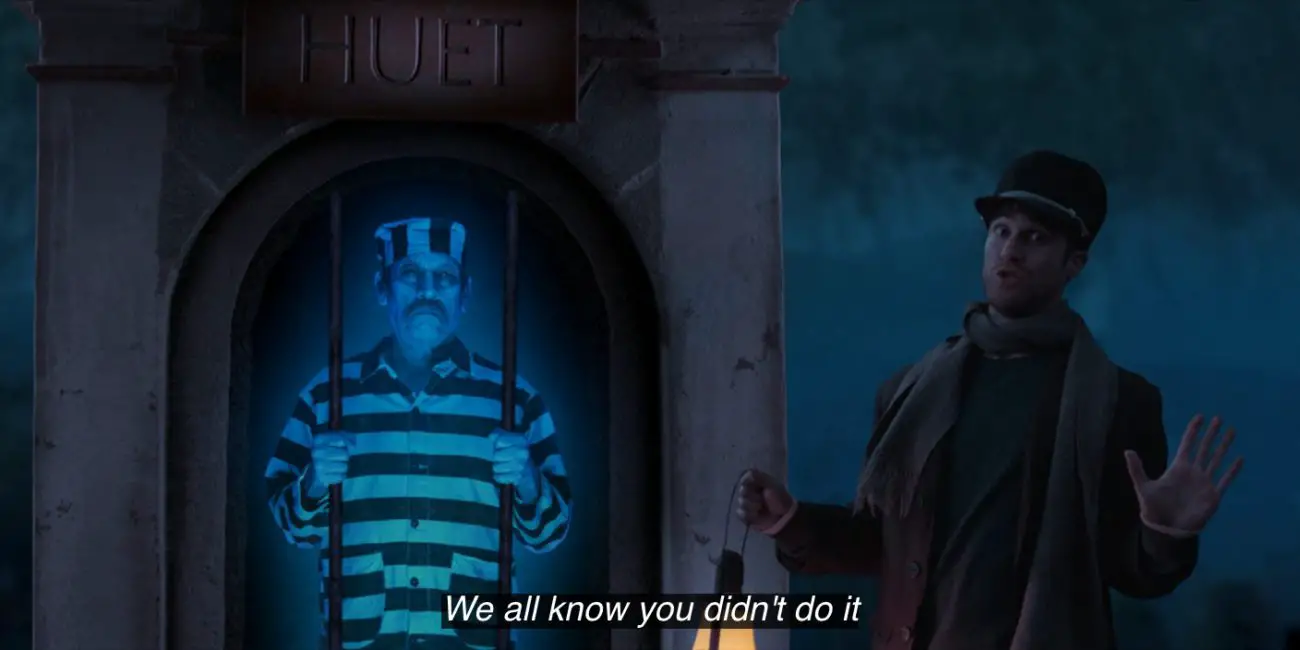 Caretaker (Darren Criss) puts his hands up and sings, "We all know you didn't do it," next to the ghost of Cousin Huet (Danny Trejo), who's wearing a striped prisoner's uniform, in the 2021 special, "Muppets Haunted Mansion."