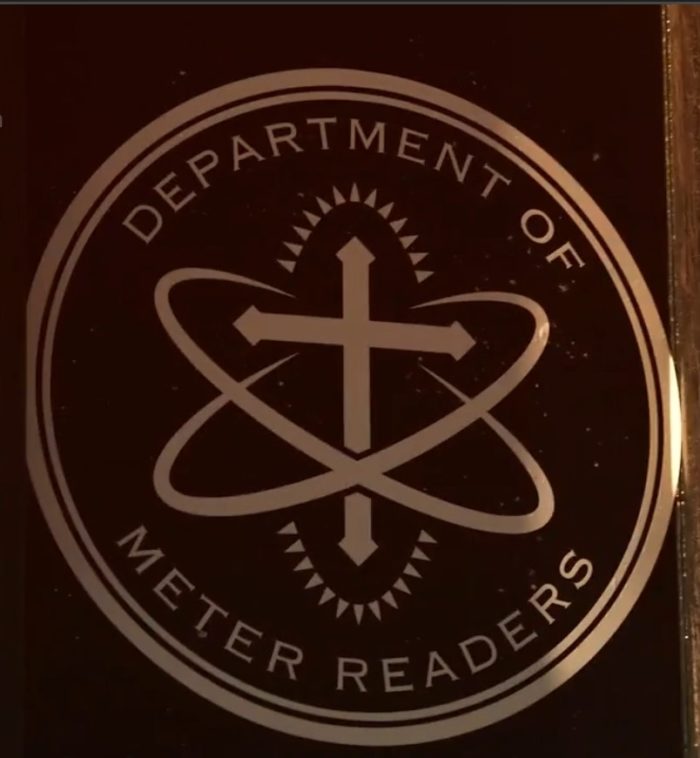 The logo for Department of Meter Readers. An atom with a Christian cross inside it.