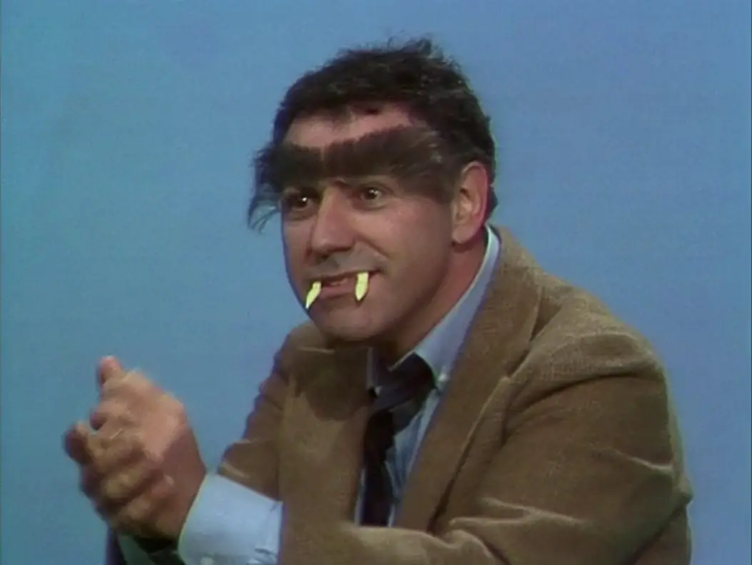 Alan Arkin, in his "Hyde" form, smiles and rubs his hands together, from the TV show, "The Muppet Show."