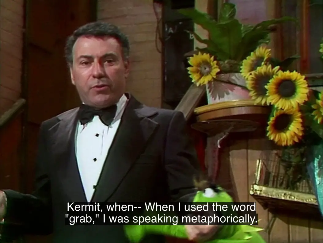 Alan Arkin says, "Kermit, when-- When I used the word 'grab,' I was speaking metaphorically," while Kermit the Frog, in his "Hyde" form, bites his forearm and hangs on, from the TV show, "The Muppet Show."