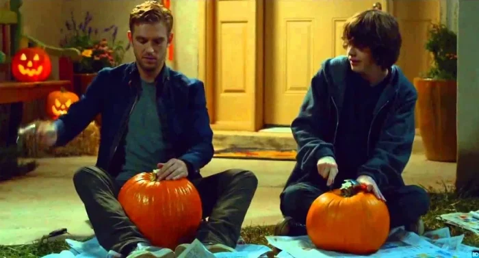 David and Luke carving pumpkins