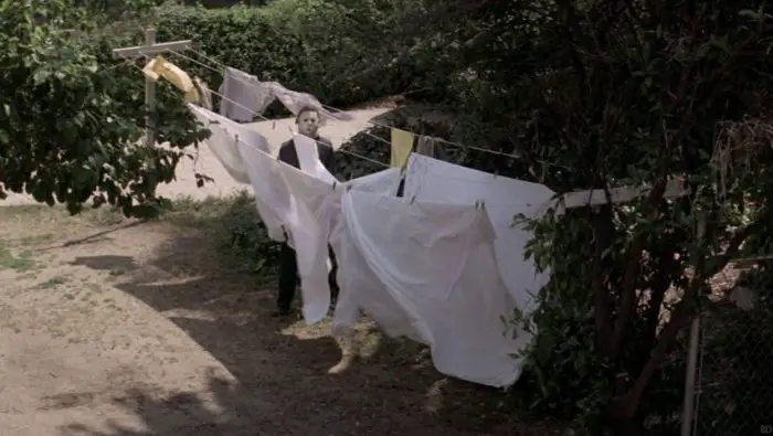 Michael Myers standing next to some sheets