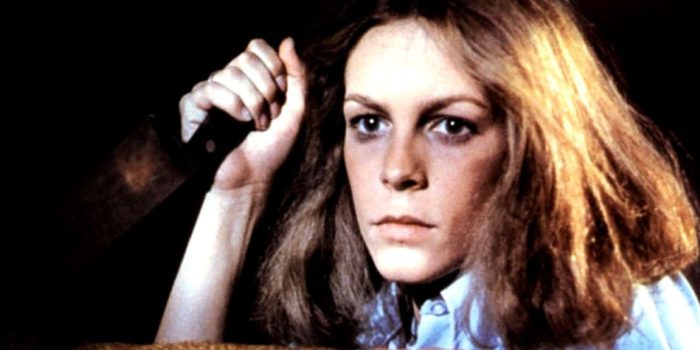 Jamie Lee Curtis as Laurie Strode in Halloween wields a butcher knife.