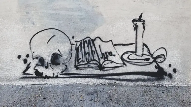 An ink drawing of a skull, book, and candle.
