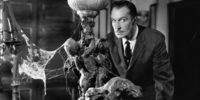 Vincent Price in House on Haunted Hill (1959), looking suspicious while surrounded by furniture laden with cobwebs