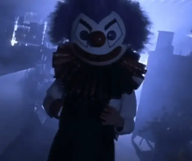 The Crimson Clown, now life-sized, walking towards the screen