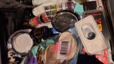 A basket of effects makeup products: brushes, contacts, blood, makeup stacks, and sponges.