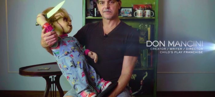 Don Mancini, credited as the "Creator/Writer/Director" for the "Child's Play" franchise, holds a knife-wielding Chucky doll during his interview for the series, "Behind the Monsters."