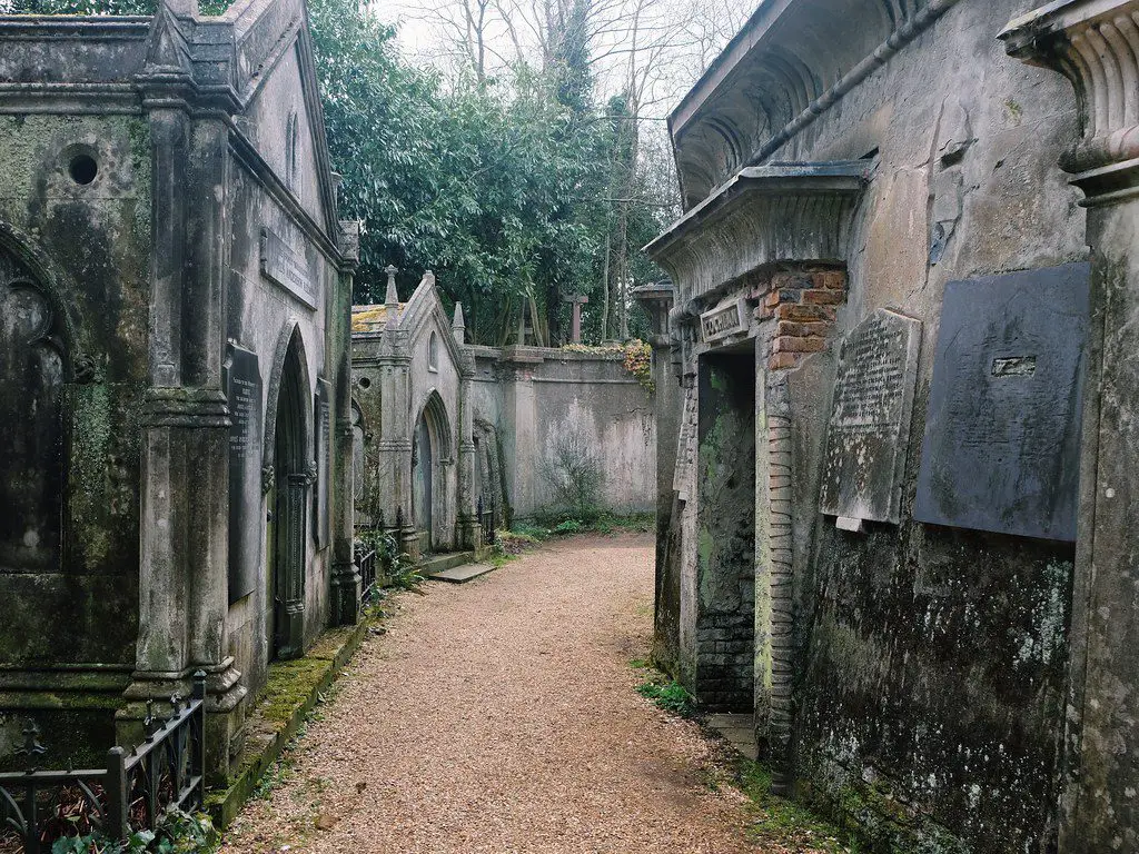 A daytime shot of mausoleums in a cemetery.